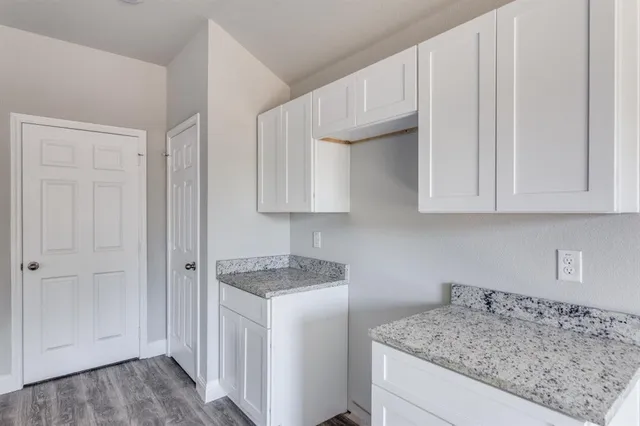 a bathroom with a granite countertop sink