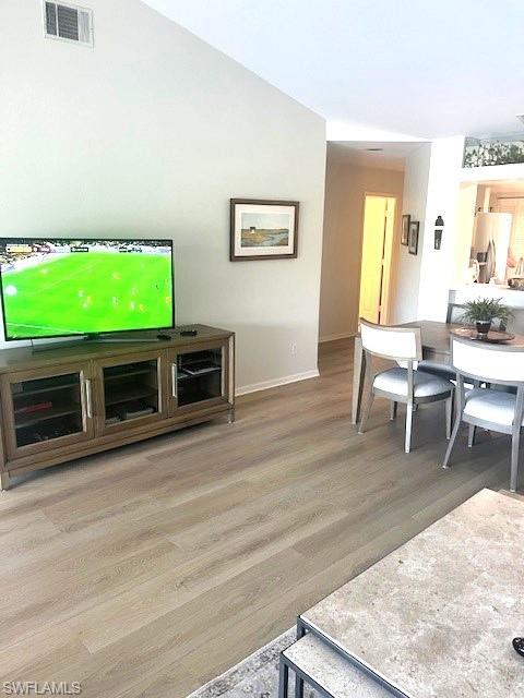 6250 Bellerive Avenue, Unit 5 Naples, FL 34119 - Photo 12 of 37 a living room with fireplace furniture and a flat screen tv