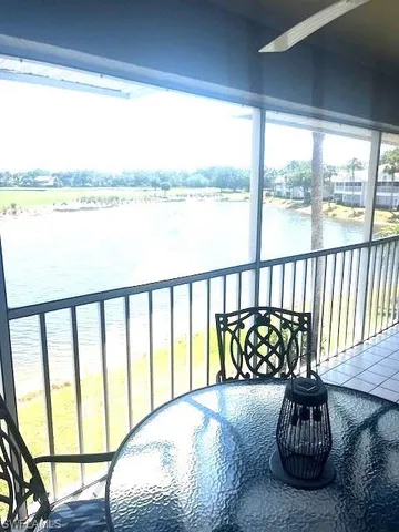 a bed sitting in a bedroom next to a large window