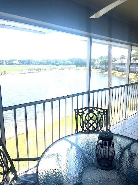 6250 Bellerive Avenue, Unit 5 Naples, FL 34119 - Photo 17 of 37 a bed sitting in a bedroom next to a large window