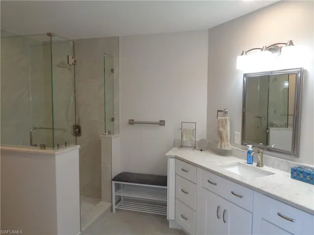 a bathroom with a granite countertop sink a toilet and a mirror