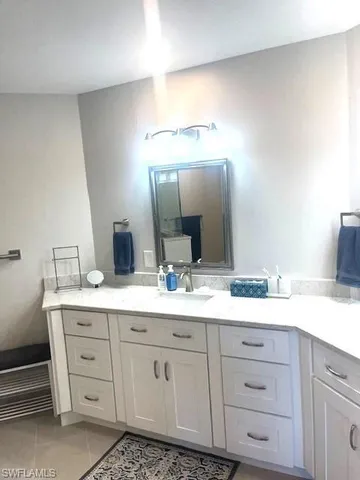 a bathroom with a double vanity sink and mirror