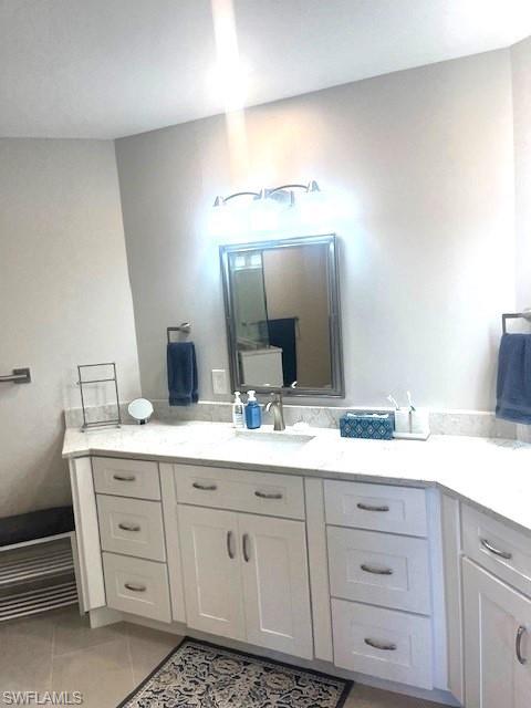 6250 Bellerive Avenue, Unit 5 Naples, FL 34119 - Photo 23 of 37 a bathroom with a double vanity sink and mirror