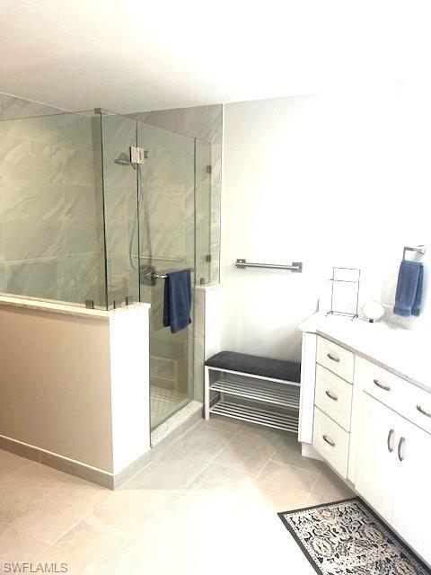 6250 Bellerive Avenue, Unit 5 Naples, FL 34119 - Photo 24 of 37 a bathroom with a sink and a mirror