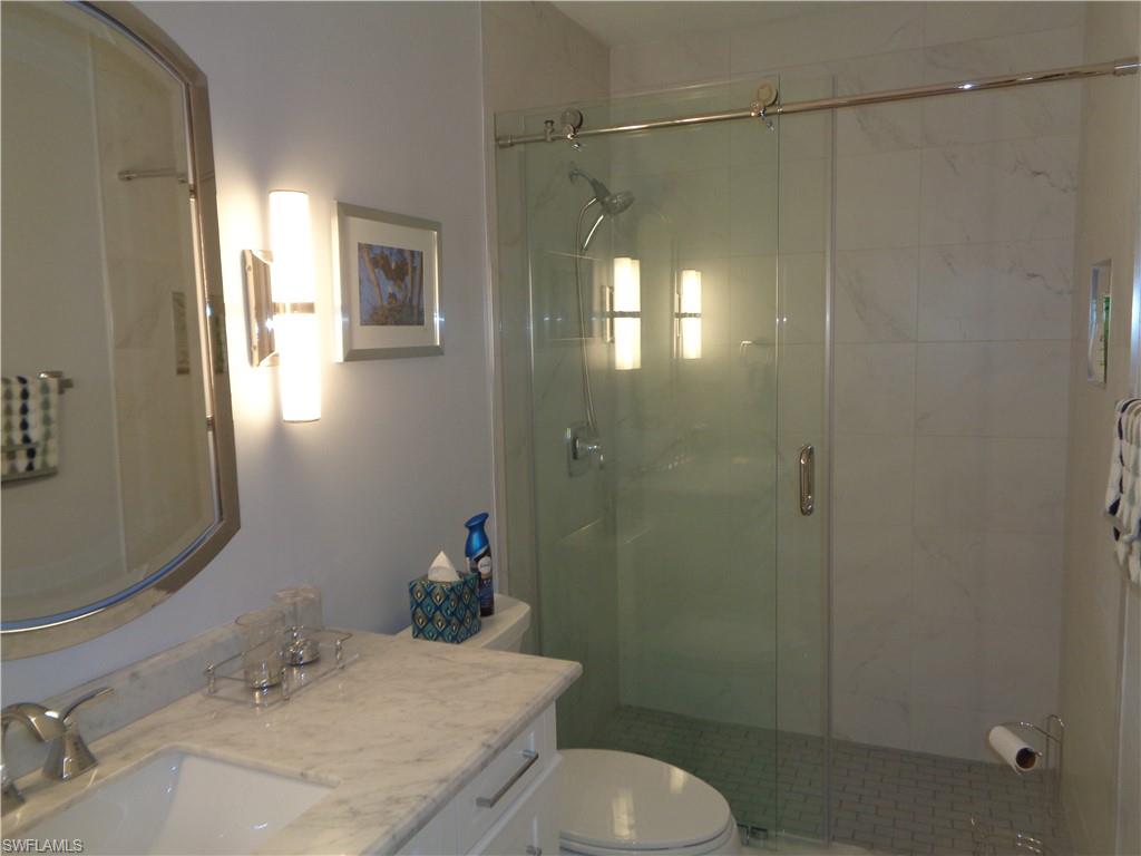 6250 Bellerive Avenue, Unit 5 Naples, FL 34119 - Photo 30 of 37 a bathroom with a sink toilet and shower