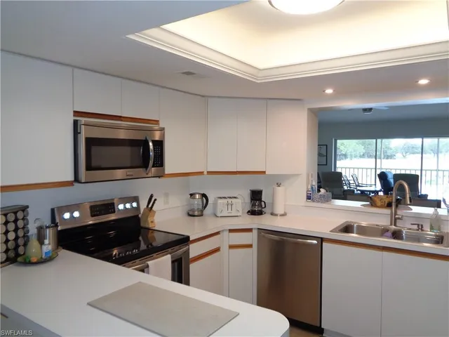 a kitchen with stainless steel appliances a sink a stove and microwave