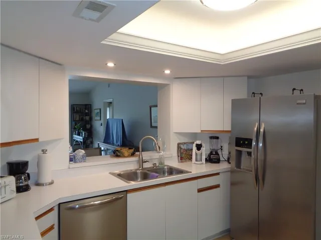 a kitchen with stainless steel appliances a sink and a refrigerator