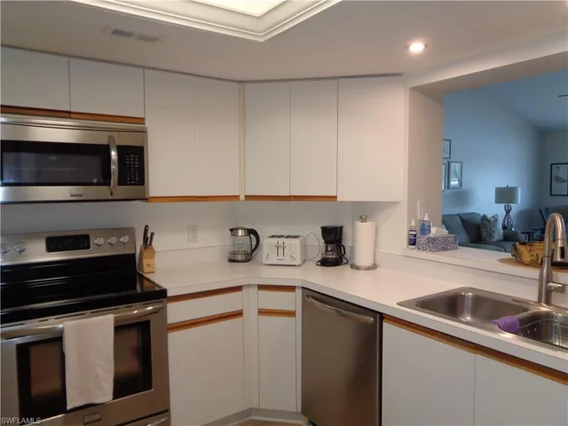 a kitchen with a sink and a stove top oven