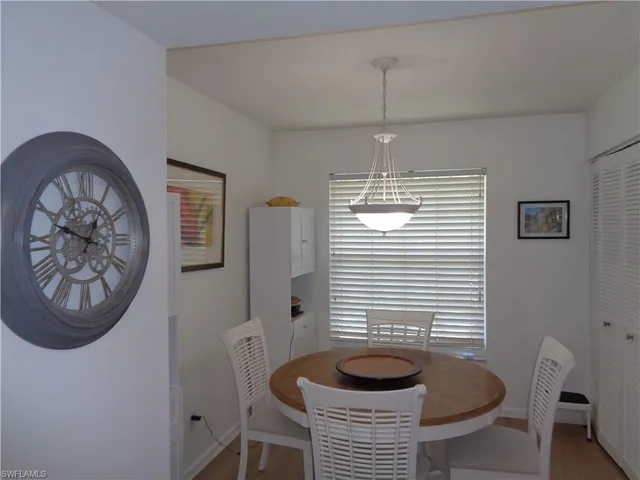 a dining room with furniture and a window