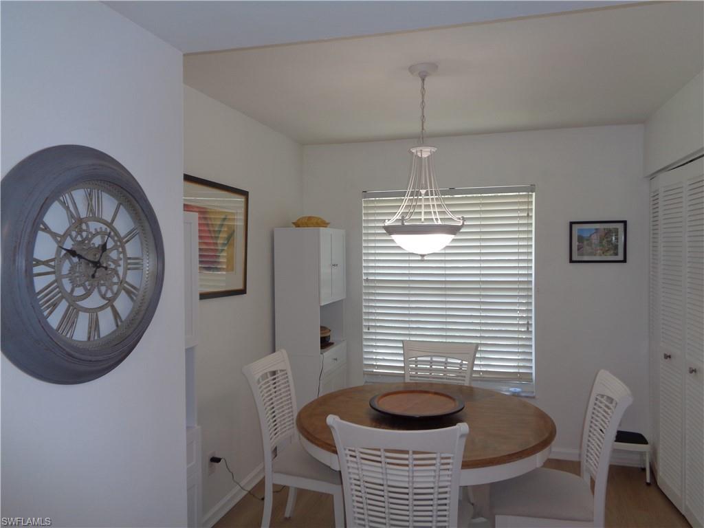 6250 Bellerive Avenue, Unit 5 Naples, FL 34119 - Photo 6 of 37 a dining room with furniture and a window