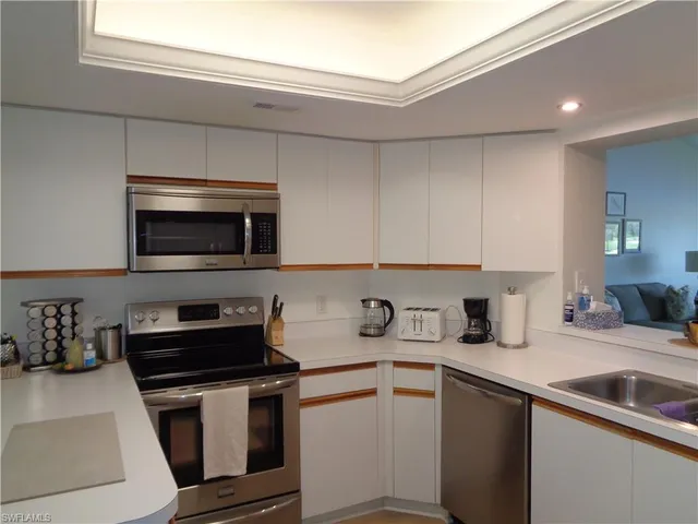 a kitchen with granite countertop a sink and a stove top oven