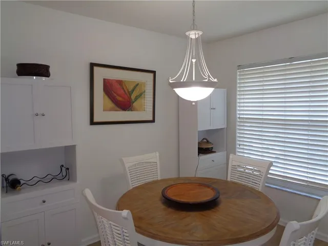 a dining room with table chairs and wooden floor