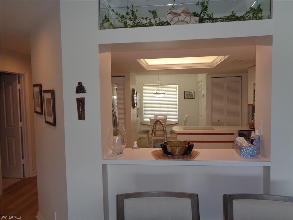 6250 Bellerive Avenue, Unit 5 Naples, FL 34119 - Photo 9 of 37 a bathroom with a sink and mirror