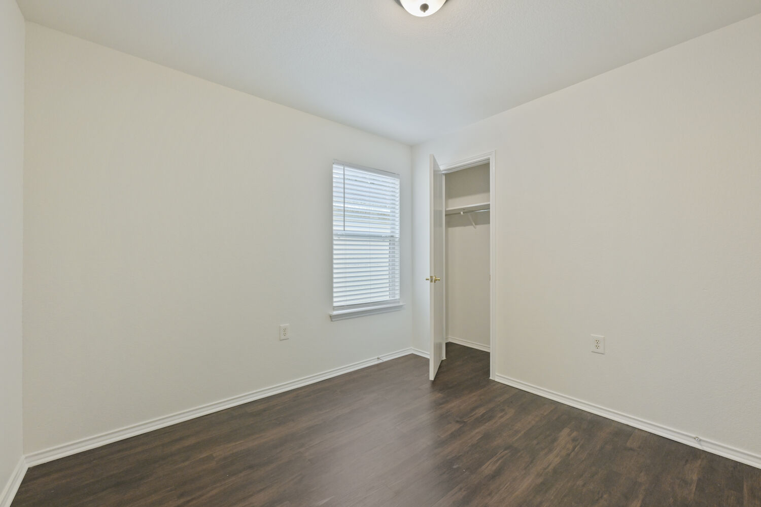 6733 Doyal Drive Austin, TX 78747 - Photo 13 of 28 Well-lit room features durable wood flooring and ample closet space.
