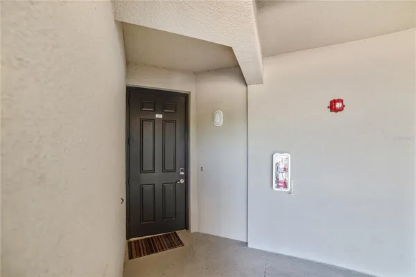 a view of a room with windows and ceiling fan