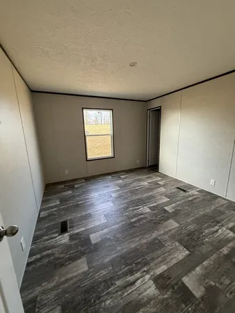 a view of wooden floor and windows in a room