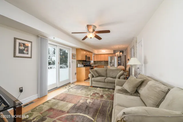 a living room with furniture and a ceiling fan
