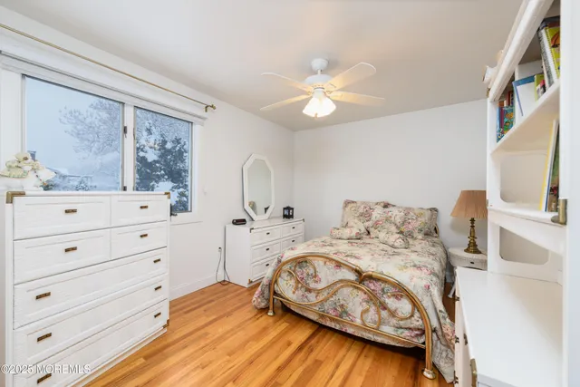 a bed sitting in a bedroom next to a window with dresser