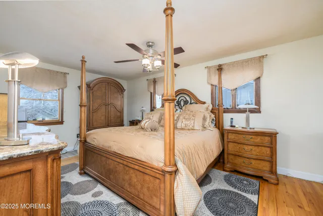 a bedroom with a bed a chandelier and dresser