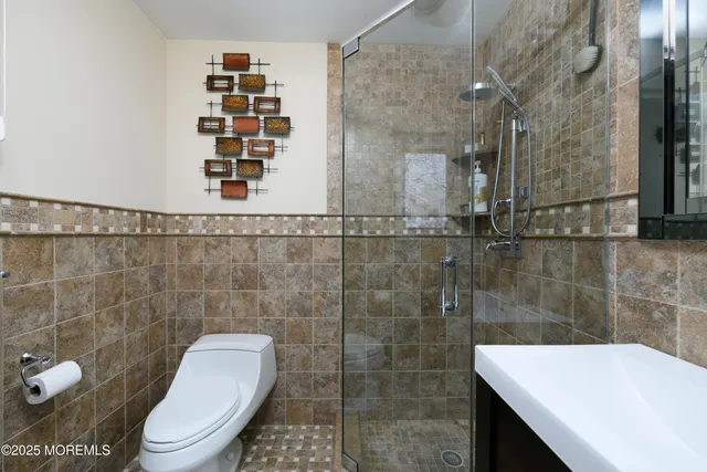 a bathroom with a toilet and a shower