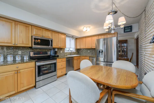 a kitchen with sink a microwave and cabinets