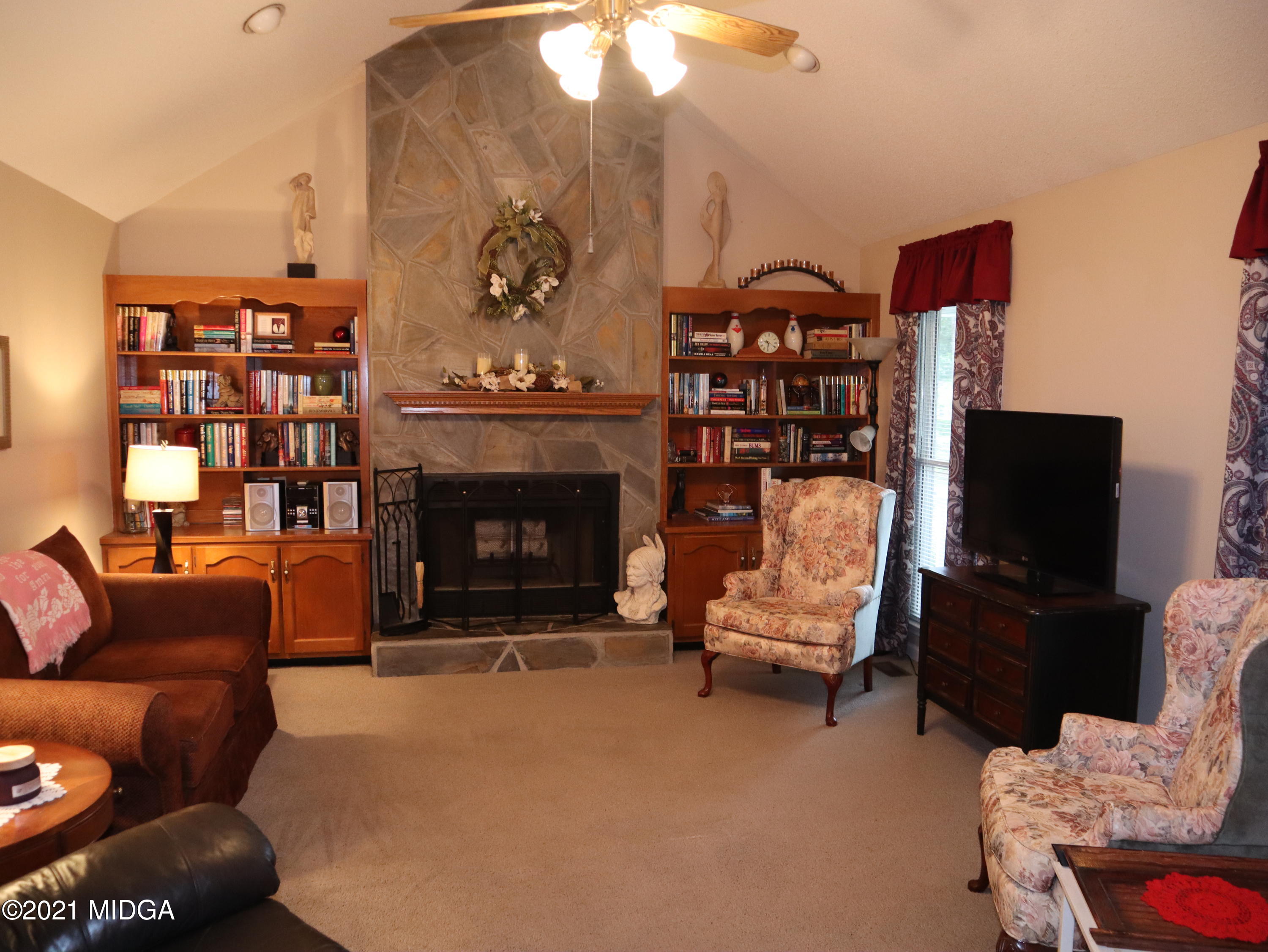 136 Timber Ridge Drive Macon, GA 31216 - Photo 3 of 20 a living room with furniture a flat screen tv and a fireplace