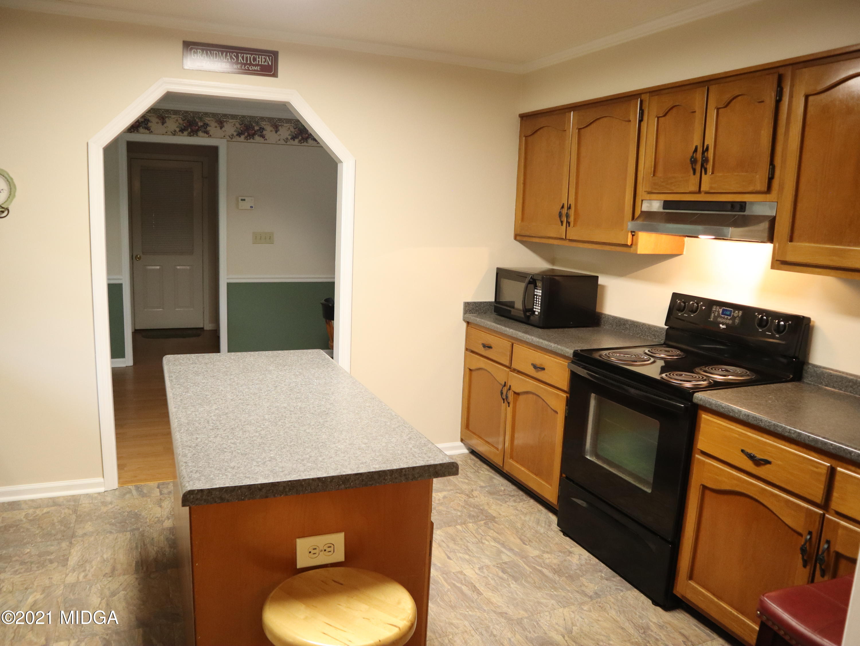 136 Timber Ridge Drive Macon, GA 31216 - Photo 5 of 20 a kitchen with stainless steel appliances a stove microwave and refrigerator