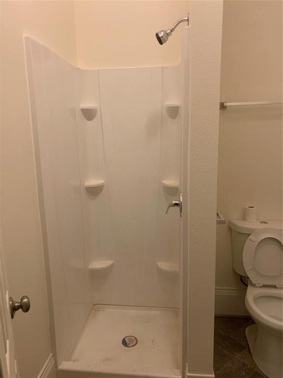 617 West Gandy Street, Unit 3 Denison, TX 75020 - Photo 11 of 14 a bathroom with a shower and toilet