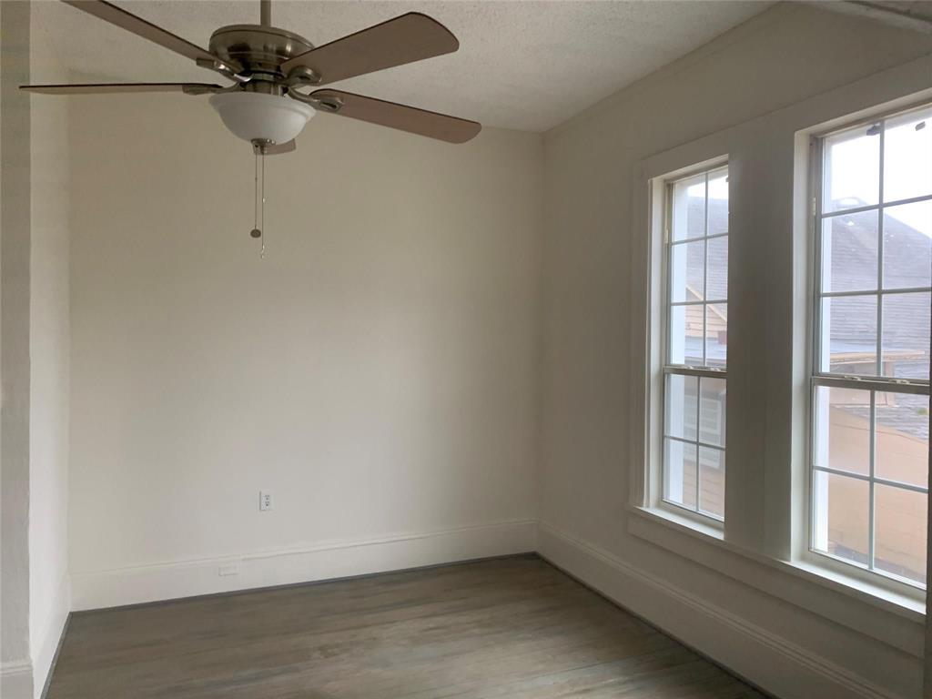 617 West Gandy Street, Unit 3 Denison, TX 75020 - Photo 2 of 14 an empty room with a window