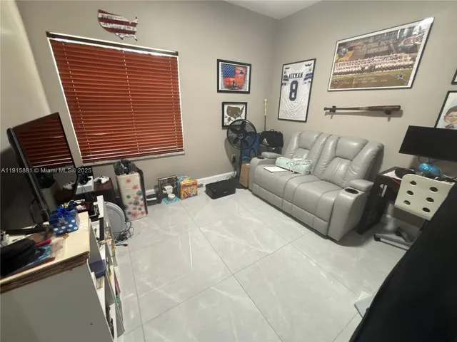 a bedroom with furniture and a window