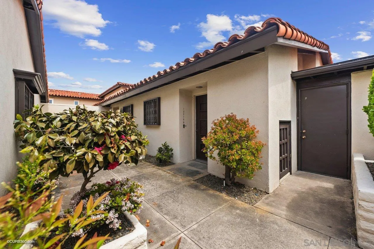 12218 Rancho Bernardo Road, Unit B San Diego, CA 92128 - Photo 1 of 30 a view of a house with a flower garden