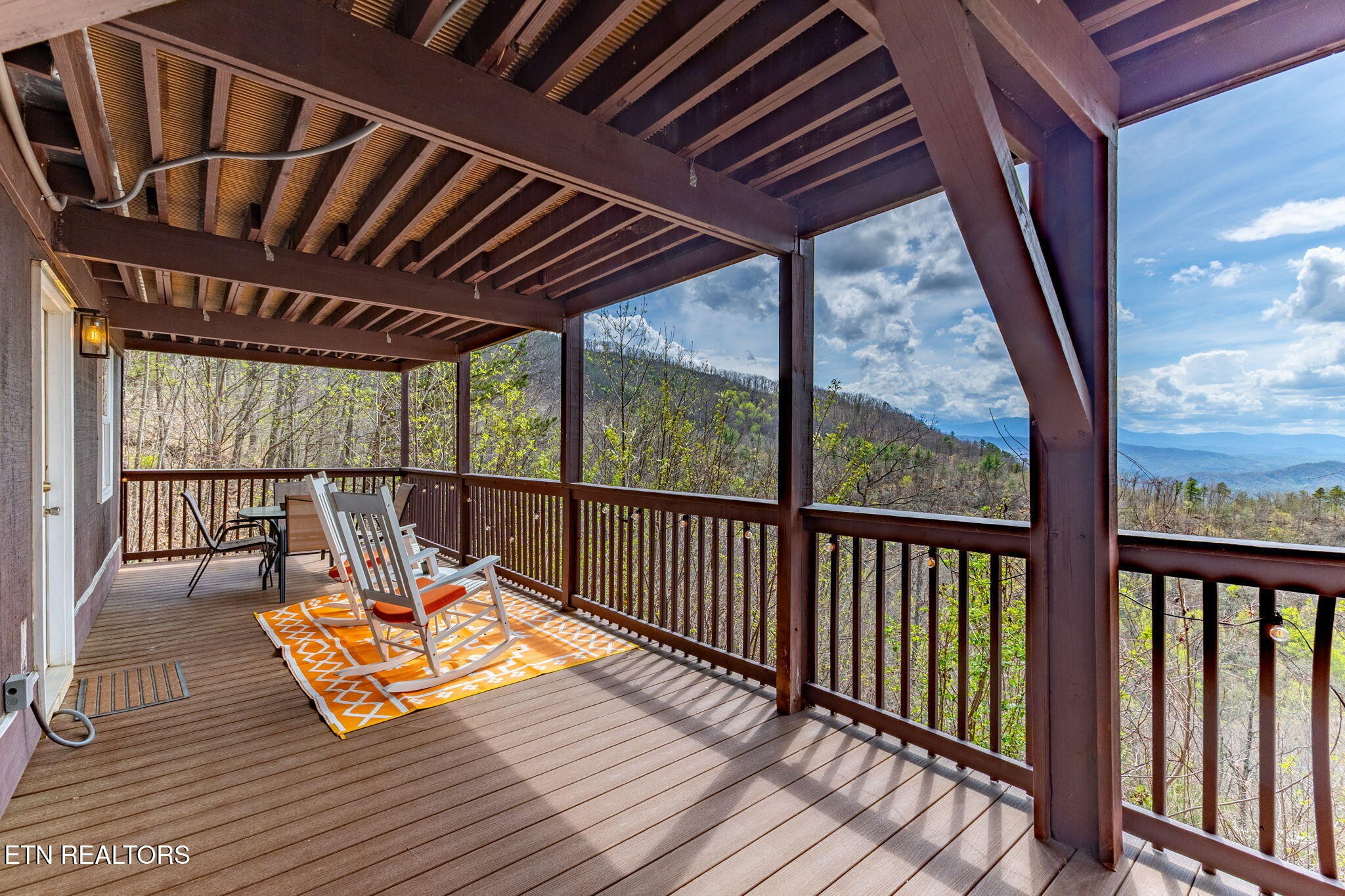 1115 Red Maple Lane Sevierville, TN 37876 - Photo 13 of 55 a balcony with wooden floor outdoor seating and yard in the back