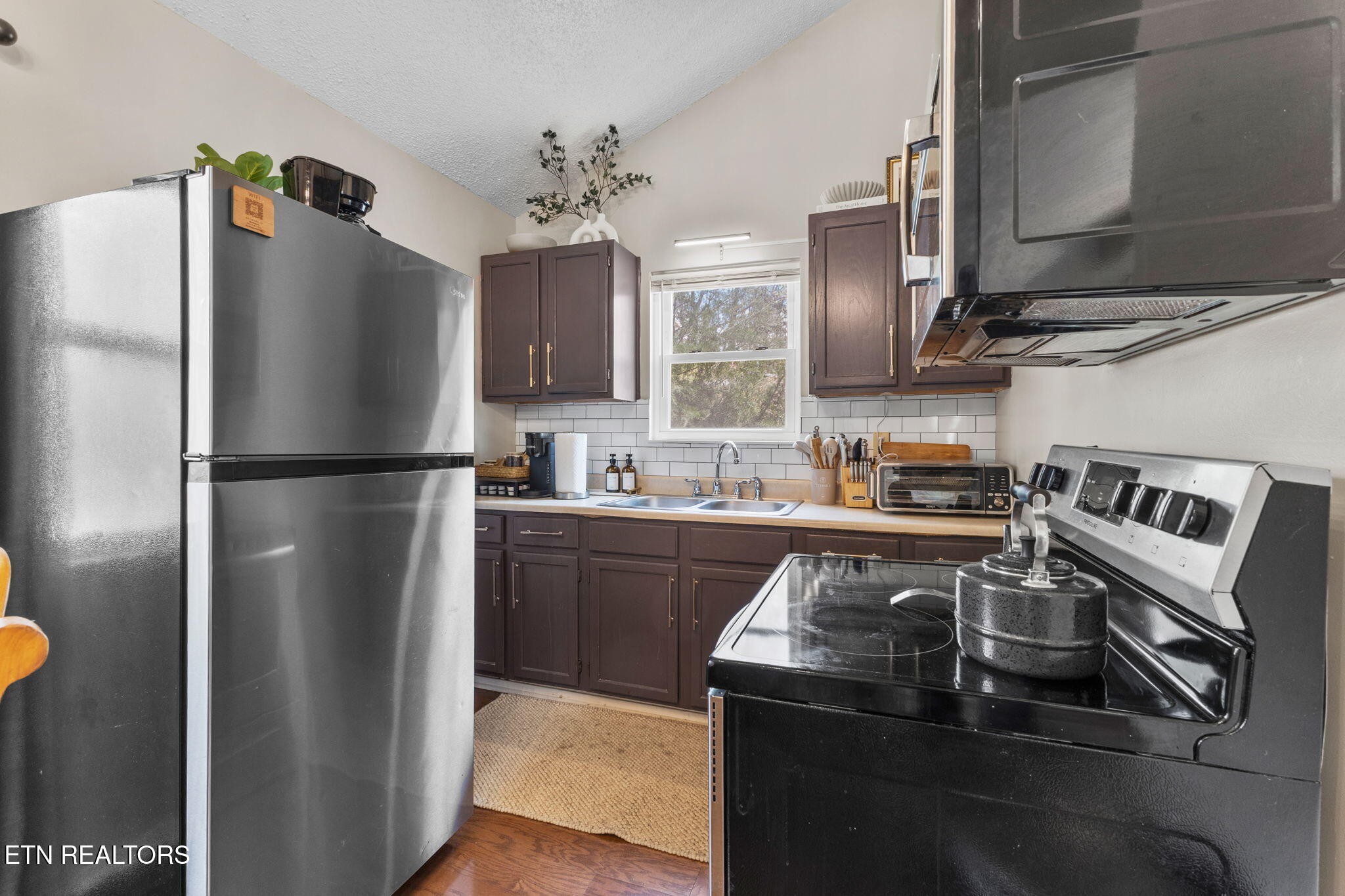 1115 Red Maple Lane Sevierville, TN 37876 - Photo 24 of 55 a kitchen with stainless steel appliances granite countertop a refrigerator a stove and a sink