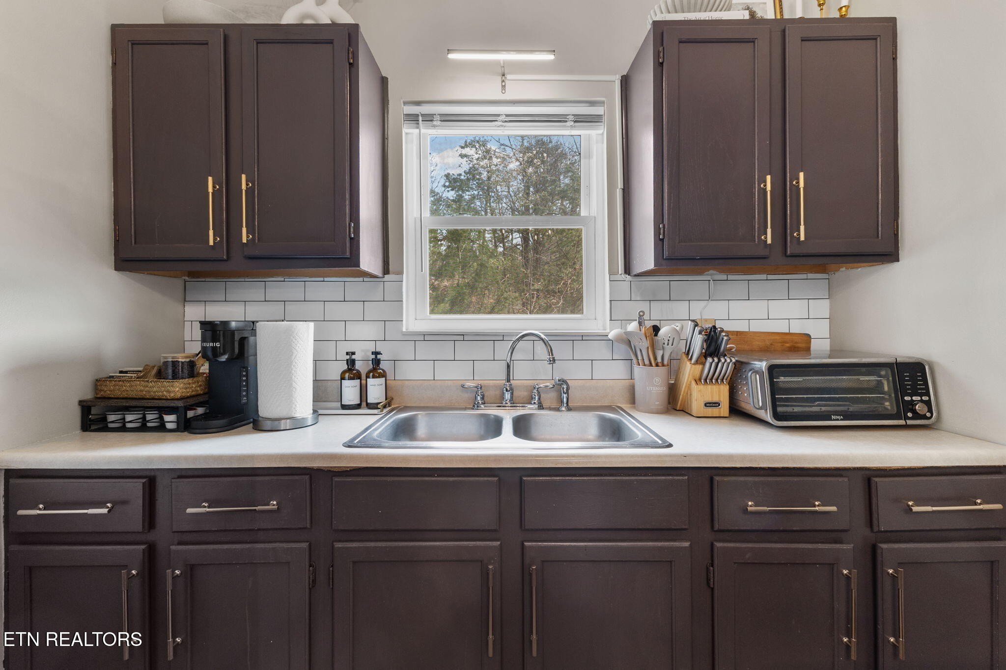 1115 Red Maple Lane Sevierville, TN 37876 - Photo 25 of 55 a kitchen with stainless steel appliances granite countertop a sink a stove and cabinets