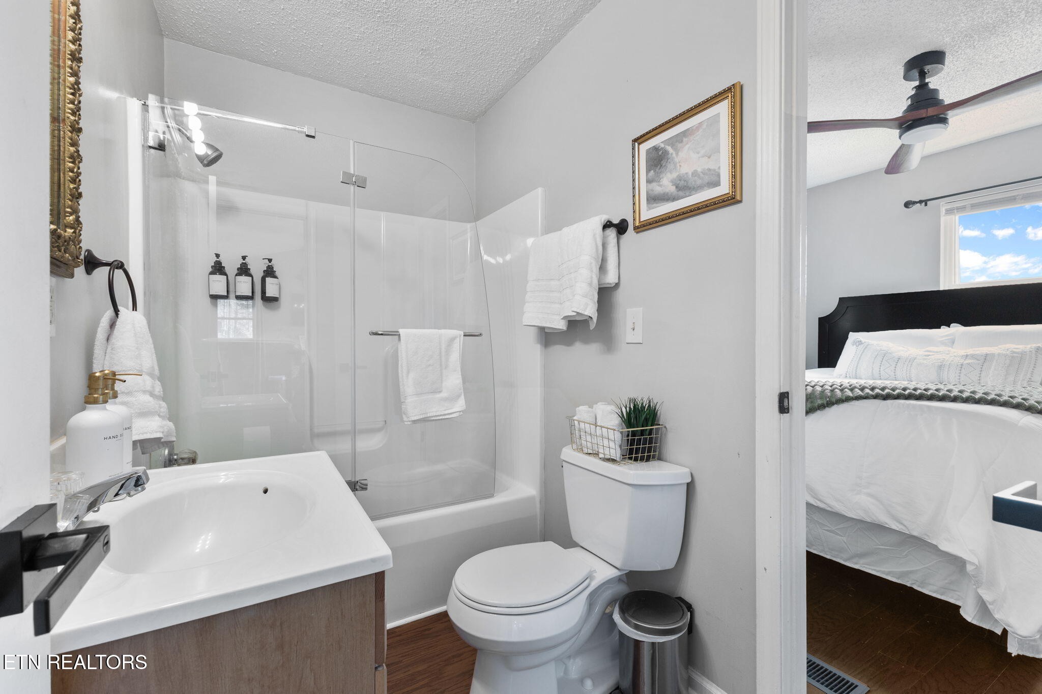 1115 Red Maple Lane Sevierville, TN 37876 - Photo 27 of 55 a white toilet sitting next to a bathroom sink and a shower