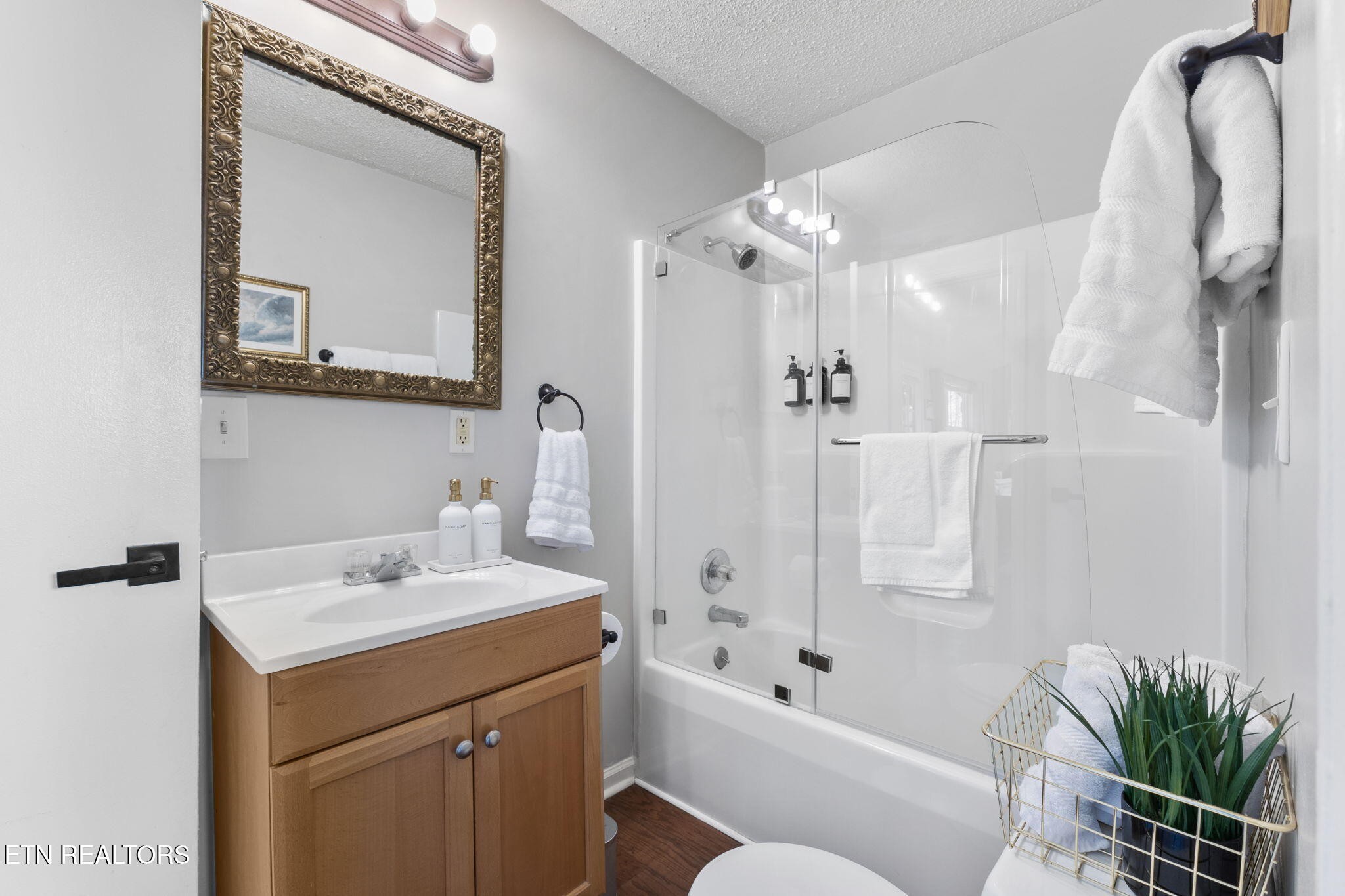 1115 Red Maple Lane Sevierville, TN 37876 - Photo 28 of 55 a bathroom with a tub a sink and mirror