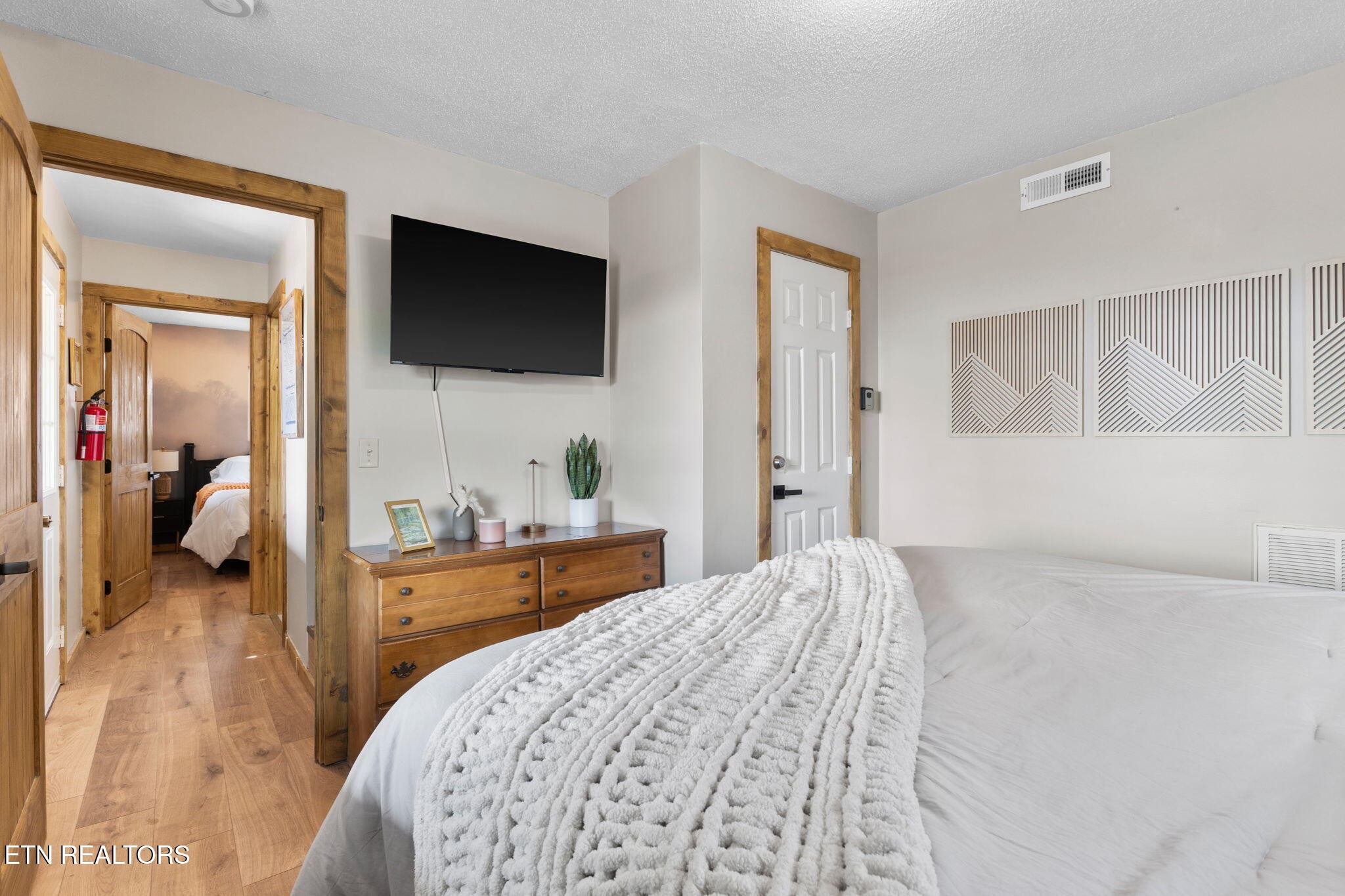1115 Red Maple Lane Sevierville, TN 37876 - Photo 35 of 55 a bedroom with a bed and a flat tv screen on wall