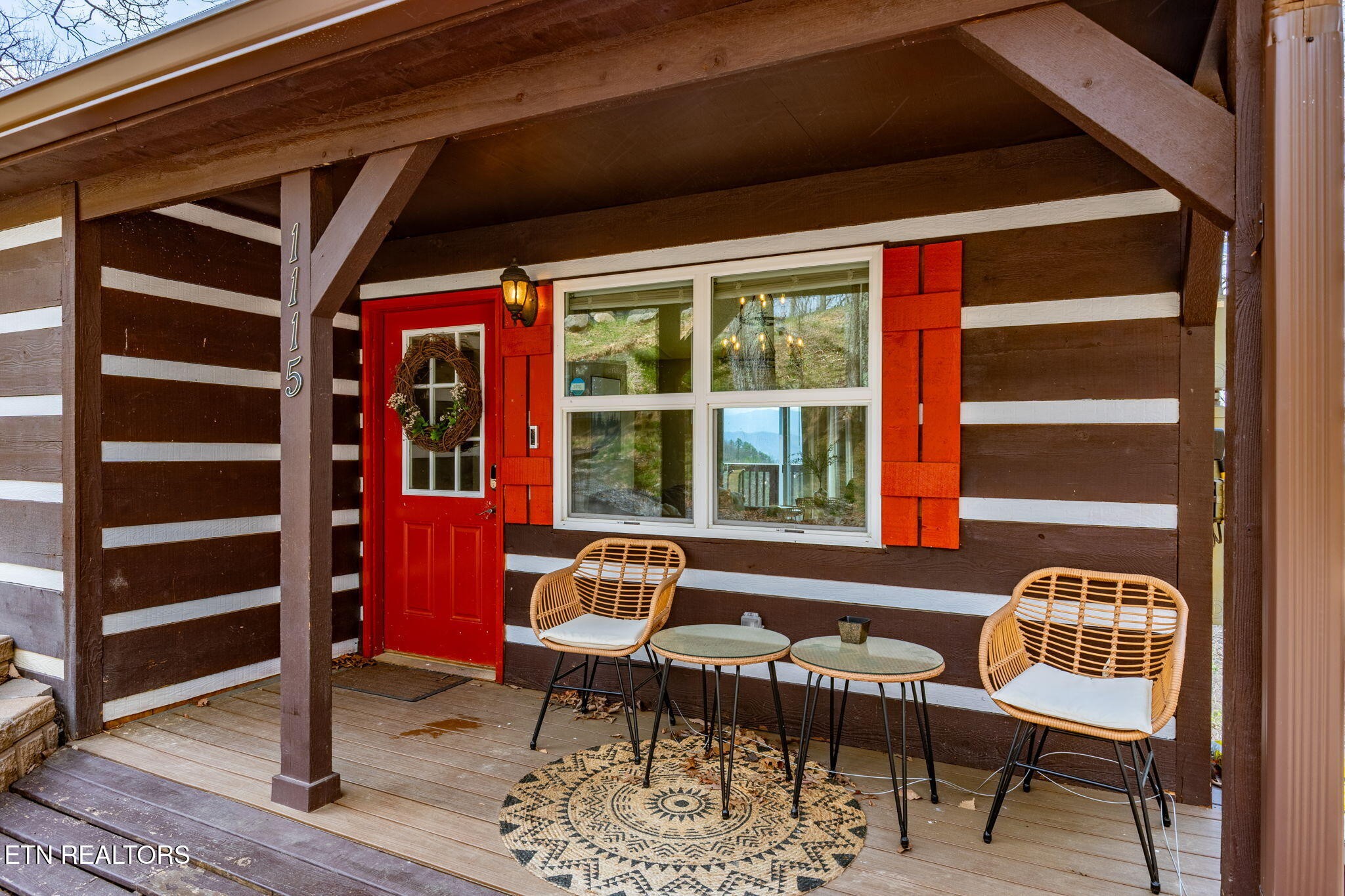 1115 Red Maple Lane Sevierville, TN 37876 - Photo 8 of 55 a balcony with furniture and wooden floor