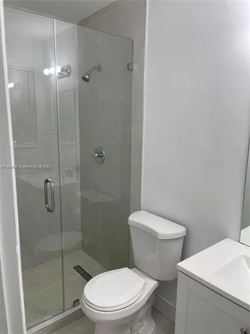 a white toilet sitting next to a bathroom sink