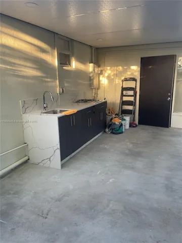 a view of an empty room with closet and window