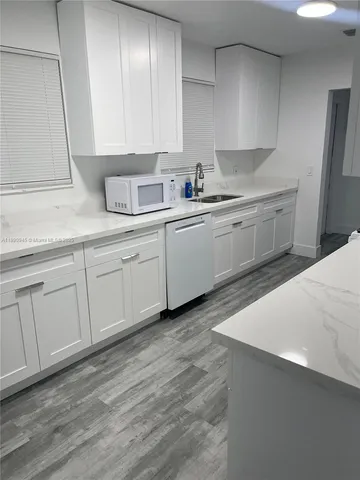 a kitchen with sink cabinets and window
