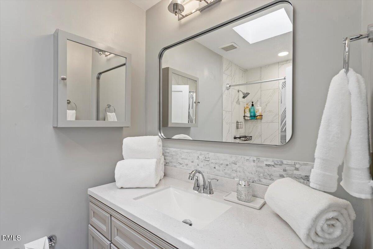 2120 Hillock Drive Raleigh, NC 27612 - Photo 20 of 29 a bathroom with a toilet sink and mirror