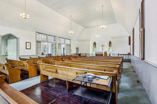 a room with a table chairs and a stove top oven