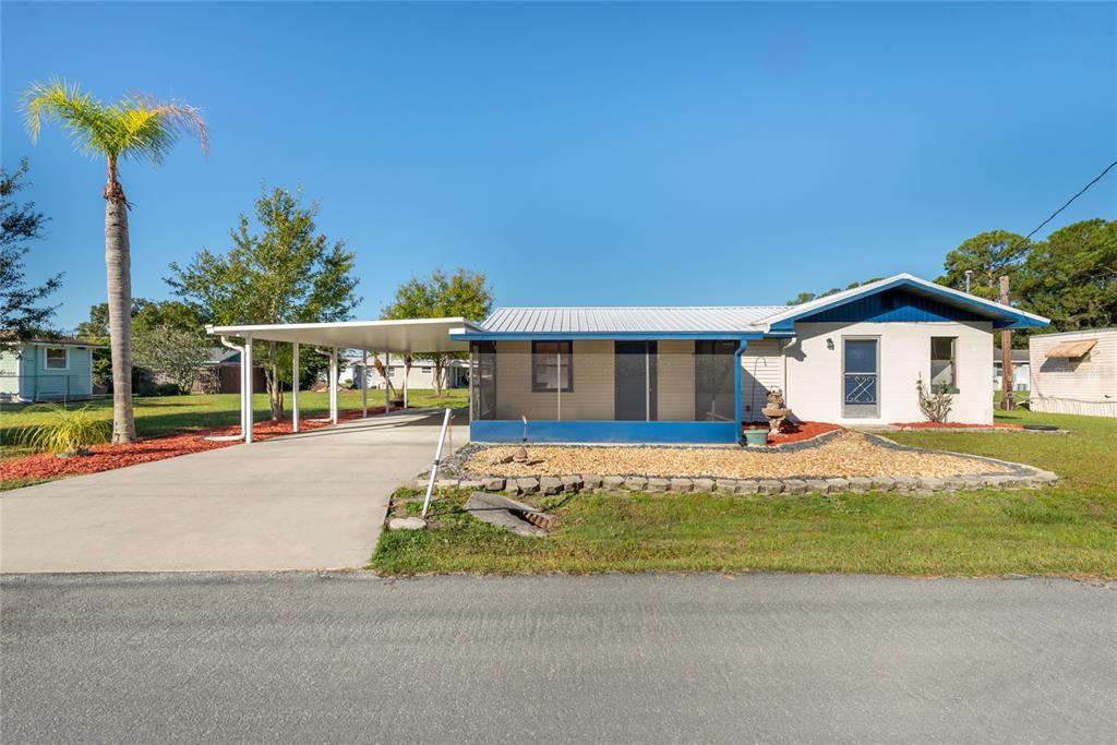 a view of house with swimming pool outdoor seating and house in the background