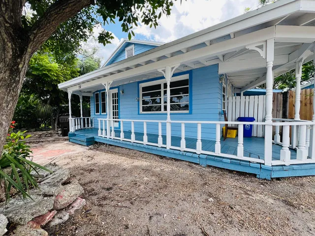 a backyard of a house with wooden floor and fence