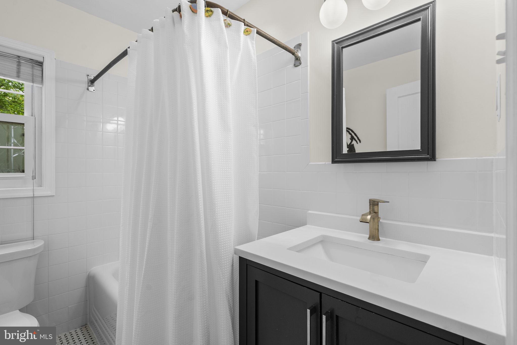 314 Dale Drive Silver Spring, MD 20910 - Photo 16 of 49 a bathroom with a sink and a mirror