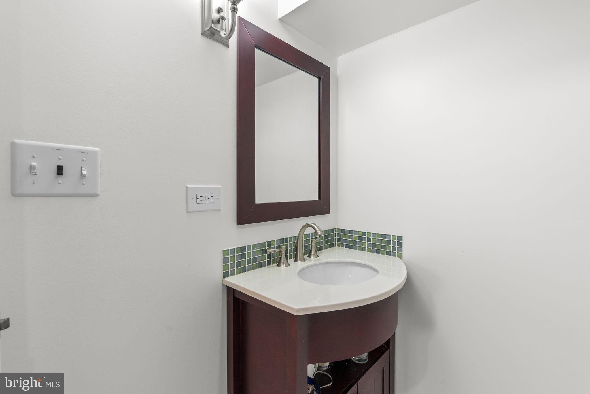 314 Dale Drive Silver Spring, MD 20910 - Photo 30 of 49 a bathroom with a sink and a mirror