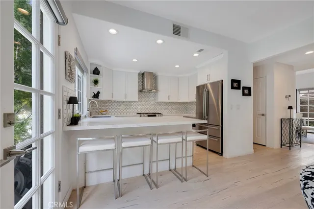 a kitchen with granite countertop white cabinets and white appliances