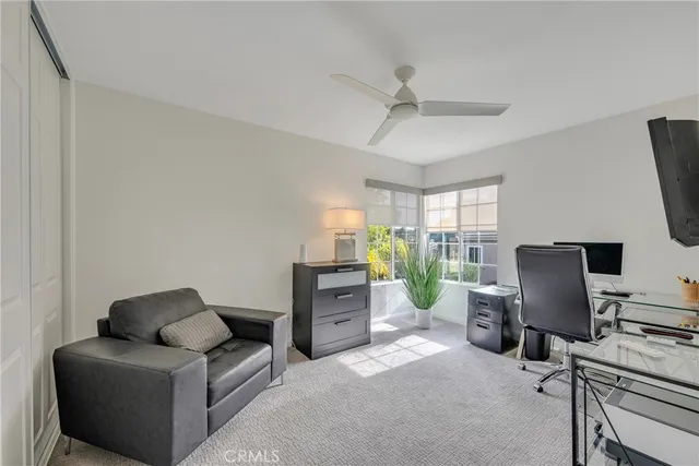 a view of a patio with table and chairs under an umbrella