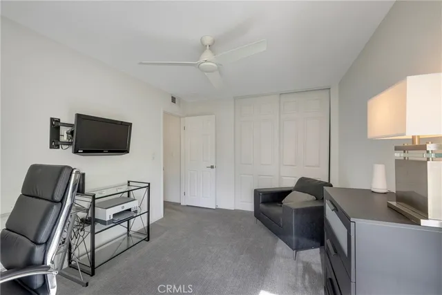 a view of a patio with table and chairs under an umbrella
